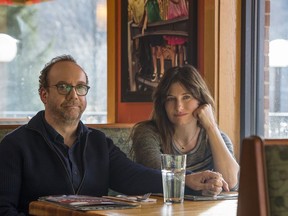 This image released by Netflix shows Paul Giamatti, left, and Kathryn Hahn in a scene from "Private Life."