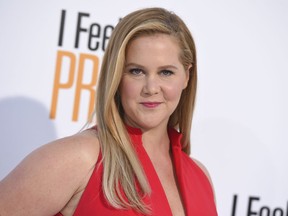 FILE - In this April 17, 2018 file photo, Amy Schumer arrives at the world premiere of "I Feel Pretty" at the Westwood Village Theater in Los Angeles. Schumer announced she's pregnant with husband Chris Fischer. She broke her baby news Monday on the Instagram stories of friend and journalist Jessica Yellin.