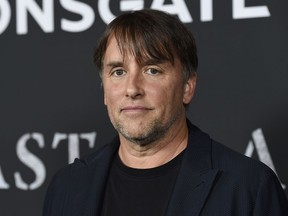 FILE - In this Nov. 1, 2017 file photo, Richard Linklater, director/co-writer of "Last Flag Flying," poses at the premiere of the film at the Directors Guild of America in Los Angeles. Linklater is the latest celebrity wading into the tight U.S. Senate race in Texas with a social media ad attacking Republican Sen. Ted Cruz.