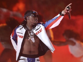 FILE - In this June 25, 2017 file photo, Quavo, of Migos, performs at the BET Awards in Los Angeles. Quavo is coming into his own as a solo artist with his debut album "Quavo Huncho" released last week.