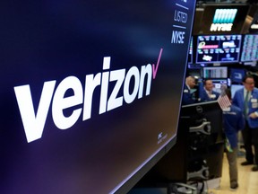 FILE- This April 23, 2018, file photo shows the logo for Verizon above a trading post on the floor of the New York Stock Exchange. Cellular companies such as Verizon are looking to challenge traditional cable companies with residential internet service that promises to be ultra-fast, affordable and wireless. Using an emerging wireless technology known as 5G, Verizon's 5G Home service provides an alternative to cable for connecting laptops, phones, TVs and other devices over Wi-Fi. It launches in four U.S. cities on Monday, Oct. 1.