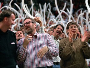 FILE - In this April 30, 1997, file photo, Portland Trail Blazers owner Paul Allen, middle, is joined by Blazers President Bob Whitsitt, left, Microsoft chairman and founder Bill Gates, right and fans as they celebrate the Blazers 98-90 win over the Los Angeles Lakers in game three of first-round NBA playoff action in Portland, Ore. Allen, billionaire owner of the Portland Trail Blazers and the Seattle Seahawks and Microsoft co-founder, died Monday, Oct. 15, 2018 at age 65. Earlier this month Allen said the cancer he was treated for in 2009, non-Hodgkin's lymphoma, had returned.