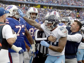 Tennessee Titans head coach Mike Vrabel, right, tries to break up a fight between Titans' linebacker Kamalei Correa (44) and Buffalo Bills offensive tackle Dion Dawkins (73) during the second half of an NFL football game, Sunday, Oct. 7, 2018, in Orchard Park, N.Y.