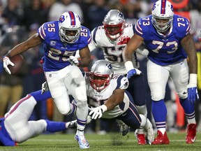 Buffalo Bills running back LeSean McCoy (25) is tripped up by New England Patriots defensive end Keionta Davis (58) during the first half of an NFL football game, Monday, Oct. 29, 2018, in Orchard Park, N.Y.