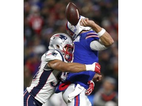 Buffalo Bills quarterback Derek Anderson, right, fumbles the ball on a hit by New England Patriots linebacker Kyle Van Noy during the second half of an NFL football game, Monday, Oct. 29, 2018, in Orchard Park, N.Y. The Patriots recovered the fumble on the play.