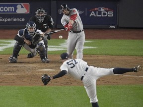 Boston Red Sox's Steve Pearce connects for a two-run RBI base hit during the fourth inning of Game 3 of baseball's American League Division Series against the New York Yankees, Monday, Oct. 8, 2018, in New York.