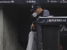 New York Yankees manager Aaron Boone blows bubbles in the dugout during the eighth inning of Game 3 of baseball's American League Division Series against the Boston Red Sox, Monday, Oct. 8, 2018, in New York.