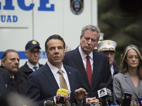 Mayor Bill de Blasio looks on as Gov. Andrew Cuomo delivers remarks during a news conference after NYPD personnel removed an explosive device from Time Warner Center Wednesday, Oct. 24, 2018, in New York.  The U.S. Secret Service says agents have intercepted packages containing "possible explosive devices" addressed to former President Barack Obama and Hillary Clinton.