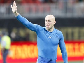 FILE - In this June 24, 2018 file photo Atlanta United goalkeeper Brad Guzan (1) waves to the crowd after an MLS soccer match against the Portland Timbers in Atlanta, Ga. Guzan is set to make his first appearance for the United States in 13 months when the Americans play Peru in an exhibition on Tuesday, Oct. 15, 2018.