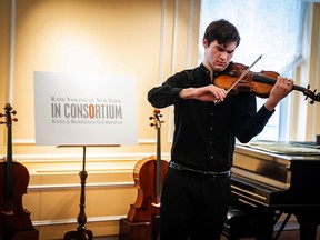 In this photo provided by Chris Lee, Juilliard student Nathan Meltzer, recipient of the "Ames, Totenberg" Stradivari of 1734, plays the instrument in New York on Tuesday, Oct. 9, 2018. The Stradivarius stolen from the late violinist Roman Totenberg and miraculously found more than three decades later has a new life, under the chin of the budding 18-year-old virtuoso.