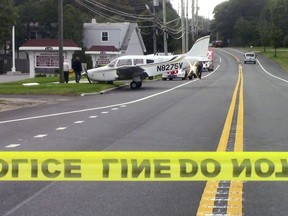 In this photo provided by Fully Involved Media Group LLC, a Piper PA-28 sits on the Montauk Highway in Center Moriches, N.Y., Saturday, Oct. 20, 2018. The Federal Aviation Administration says the aircraft landed at Lufker Airport and rolled off the runway onto the adjacent highway. There are no immediate reports of any injuries.