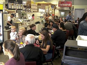 In this photo taken from video, a lunch-time crowd packs into the West Side Bazaar, where refugees sell clothes, crafts and food, on Thursday, Sept. 27, 2018, in Buffalo, N.Y. Thousands of refugees have settled in Buffalo in recent years even as others have left the city. Some locals worry that the Trump administration's policies reducing the numbers of new arrivals will harm the city's economy.