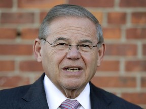 FILE - In this June 5, 2018 file photo, U.S. Sen. Bob Menendez, D-N.J., speaks to reporters after casting his vote in the New Jersey primary election at the Harrison Community Center in Harrison, N.J. Menendez held a news conference Wednesday, Oct. 17 to respond to Republican rival Bob Hugin's latest ad that refers to unproven allegations about Menendez using prostitutes in the Dominican Republic.