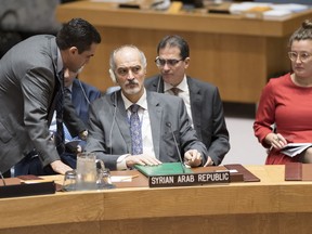 Bashar Ja'afari, center, Syrian Ambassador to the United Nations, attends a Security Council meeting, Wednesday, Oct. 17, 2018 at U.N. headquarters.