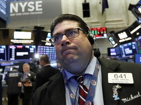 Trader Michael Capolino works on the floor of the New York Stock Exchange, Monday, Oct. 15, 2018. Stocks are opening mostly lower as technology companies continue to fall.