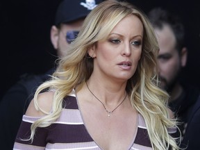 FILE - In this Thursday, Oct. 11, 2018, file photo, adult film actress Stormy Daniels arrives for the opening of the adult entertainment fair "Venus," in Berlin. On Monday, Oct. 15, 2018, a federal judge dismissed Daniels' defamation lawsuit against President Donald Trump.