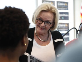 FILE - In this Tuesday, Sept. 11, 2018, file photo, Sen. Claire McCaskill, D-Mo., speaks to a supporter at a campaign stop at the University of Missouri - St. Louis, in St. Louis. Democrats are leading Republicans in the money race in many of the key Senate and House campaigns three weeks from the midterm elections that will determine who controls Capitol Hill in January. McCaskill reported $7 million in net contributions that includes $4.6 million in itemized individual contributions and another $2.18 million from non-itemized, small-dollar contributors.