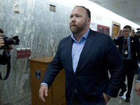FILE - In this Wednesday, Sept. 5, 2018, file photo, Alex Jones, the right-wing conspiracy theorist, walks the corridors of Capitol Hill after listening to testimony on Capitol Hill in Washington. On Tuesday, Oct. 23, 2018, Twitter confirmed it has removed accounts linked to conspiracy-monger Alex Jones and Infowars.
