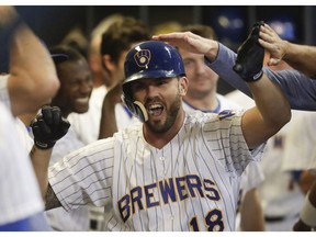 FILE - In this Friday, Sept. 14, 2018, file photo, Milwaukee Brewers' Mike Moustakas is congratulated after hitting a home run during the seventh inning of a baseball game against the Pittsburgh Pirates, in Milwaukee. Brewers third baseman Moustakas declined a $15 million mutual option on Tuesday, Oct. 30, 2018, thus becoming a free agent again.