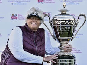 In this photo provided by the LPGA, golfer Laura Davies poses for a photo with her trophy, Wednesday, Oct. 17, 2018, in French Lick, Ind. Davies won the Senior LPGA Championship on Wednesday to sweep the two senior major events of the year.