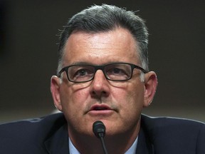 FILE - In this Tuesday, June 5, 2018, file photo, former USA Gymnastics president Steve Penny invokes his right under the Fifth Amendment not to answer questions during a Senate Subcommittee on Consumer Protection, Product Safety, Insurance, and Data Security, on Capitol Hill in Washington. In a statement late Wednesday, Oct. 17, 2018, the Walker County district attorney's office in Huntsville, Texas, said that Penny has been arrested after a Texas grand jury indicted him, alleging he tampered with evidence in the sexual assault investigation of now-imprisoned gymnastics doctor Larry Nassar. Penny now awaits extradition to Texas.