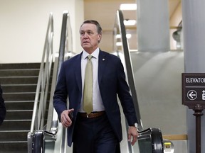 FILE - In this Thursday, Oct. 4, 2018, file photo, Sen. David Perdue, R-Ga., arrives on Capitol Hill, in Washington. A Georgia Tech political group says Perdue snatched a phone from a student who was video recording while asking the Republican lawmaker a question about Georgia's governor's race. In a statement, a Perdue spokesperson said the senator thought he was being asked to take a picture, so he grabbed the phone to take a selfie.