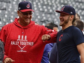Cleveland Indians manager Terry Francona, left, and infielder Josh Donaldson laugh during a baseball team workout, Tuesday, Oct. 2, 2018, in Cleveland. The Indians will play the Houston Astros Friday in Game 1 of the AL Division Series.