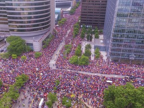 In this June 22, 2016 photo, the crowd wait in the parade route in downtown Cleveland to celebrate the Cavaliers basketball team's NBA championship. This photo showing a crowd of nearly one million people engulfing major roadways was not taken during a President Donald Trump rally in Houston this week, as several people falsely claimed on social media.But the image circulating on social media was snapped in June 2016 during a million-person parade that took place in downtown Cleveland to celebrate the Cavaliers' NBA championship. Using a drone, Bruce Bishop and Matt Mishak took the photo while covering the event for the Chronicle-Telegram, a newspaper in Elyria, Ohio.