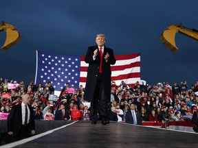 President Donald Trump waves as he arrives for a campaign rally, Friday, Oct. 12, 2018, in Lebanon, Ohio.