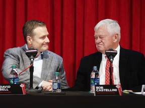 Cincinnati Reds manager David Bell, left, shakes hands with Bob Castellini, CEO, right, during a news conference, Monday, Oct. 22, 2018, in Cincinnati. Bell has been hired as manager of the Cincinnati Reds, tasked with helping turn around a team that skidded to a 67-95 record and last-place finish in the NL Central. The Reds said Sunday, Oct. 21, 2018, he has been given a three-year contract that includes a team option for 2022.