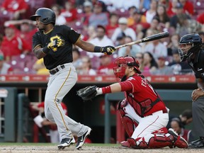 Pittsburgh Pirates' Pablo Reyes hits a double off Cincinnati Reds relief pitcher Jackson Stephens in the 10th inning of a baseball game, Sunday, Sept. 30, 2018, in Cincinnati.