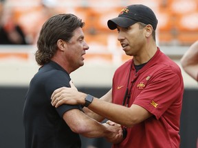 Oklahoma State head coach Mike Gundy, left, shakes hands with Iowa State head coach Matt Campbell, right, before an NCAA college football game in Stillwater, Okla., Saturday, Oct. 6, 2018.