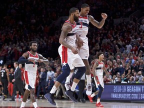 Washington Wizards forward Markieff Morris, left, and guard Bradley Beal celebrate during the overtime of an NBA basketball game against the Portland Trail Blazers in Portland, Ore., Monday, Oct. 22, 2018. Washington won 125-124.