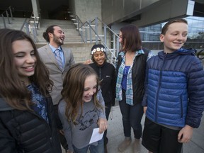 FILE  - In this Nov. 10, 2016 file photo, five of the 21 youth plaintiffs in a federal climate change lawsuit against the federal government, including, from left, Sahara Valentine, 11, Jacob Lebel, 19, Avery McRae, 10, Miko Vergun, 15, Kelsey Julianna, 20, and Zealand Bell, 11, celebrate on the courthouse steps in Eugene, Ore., after U.S. District Judge Ann Aiken rejected requests from the federal government and trade groups representing many of the world's largest energy companies to dismiss their lawsuit. The U.S. government is trying once again to block a major climate change lawsuit days before young activists are set to argue at trial that the government has violated their constitutional rights by failing to take action climate change. On Thursday, Oct. 18, 2018, the Justice Department for a second time this year asked the U.S. Supreme Court to dismiss the case. The high court in July denied the request as premature.