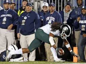 Michigan State's Felton Davis (18) goes in for the winning touchdown after a catch as Penn State's Amani Oruwariye (21) misses the tackle during the second half of an NCAA college football game in State College, Pa., Saturday, Oct. 13, 2018.