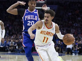 Atlanta Hawks' Trae Young, right, drives to the basket against Philadelphia 76ers' Markelle Fultz, left, during the first half of an NBA basketball game, Monday, Oct. 29, 2018, in Philadelphia.