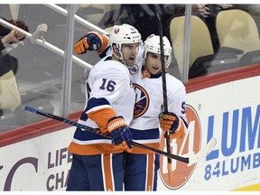 New York Islanders left wing Andrew Ladd (16) celebrates with New York Islanders center Valtteri Filppula (51) after scoring a goal against the Pittsburgh Penguins during the first period of an NHL hockey game in Pittsburgh, Tuesday, Oct. 30, 2018.