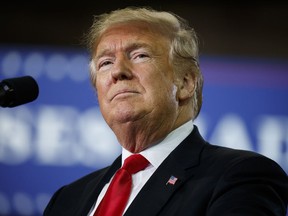 President Donald Trump pauses as he speaks at a campaign rally at Erie Insurance Arena, Wednesday, Oct. 10, 2018, in Erie, Pa. As Hurricane Michael pounded the Southeast on Wednesday, Trump took shelter at the campaign rally in Pennsylvania, where he sought to boost Republicans before the midterms.