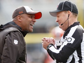 Cleveland Browns head coach Hue Jackson, left, talks with line judge Mike Spanier (90) along the sideline as his team plays against the Pittsburgh Steelers Sunday, Oct. 28, 2018, in Pittsburgh. The Steelers won 33-18.