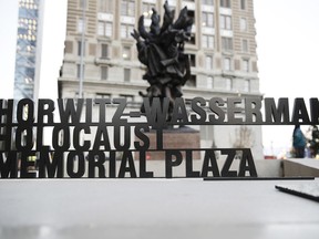 A sign is displayed at the redesigned Holocaust Memorial Plaza in Philadelphia, Monday, Oct. 22, 2018. The memorial that originally opened in 1964 has been expanded and enhanced to focus on both remembrance and education.