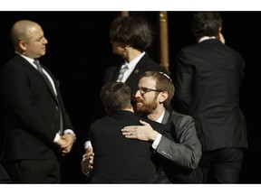 Mourners hug outside Rodef Shalom Congregation during the funeral services for brothers Cecil and David Rosenthal, Tuesday, Oct. 30, 2018, in Pittsburgh. The brothers were killed in the mass shooting Saturday at the Tree of Life synagogue.