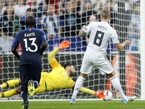 Germany's Toni Kroos, right, scores his side opening goal during their UEFA Nations League soccer match between France and Germany at Stade de France stadium in Saint Denis, north of Paris, Tuesday, Oct. 16, 2018.