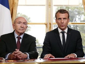 FILE - In this Monday, Oct. 30, 2017 file photo French President Emmnauel Macron, right, flanked by French Interior Minister Gerard Collomb, addresses the media after signing a counterterrorism law, at the Elysee Palace, in Paris, France. An official at the French presidency said President Emmanuel Macron will quickly replace high-profile interior minister Gerard Collomb, whose resignation has not been formalized yet.