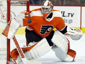 Philadelphia Flyers goalie Brian Elliott defends as a puck comes towards him during the first period of an NHL hockey game against the Florida Panthers, Tuesday, Oct. 16, 2018, in Philadelphia.