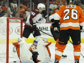 Philadelphia Flyers goalie Brian Elliott lies on his stomach after the goal by Colorado Avalanche's Mikko Rantanen during the first period of an NHL hockey game, Monday, Oct. 22, 2018, in Philadelphia. At right is Flyers' Christian Folin.