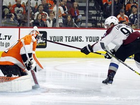 Colorado Avalanche' Gabriel Landeskog, right, scores a goal past Philadelphia Flyers goalie Brian Elliott during the third period of an NHL hockey game, Monday, Oct. 22, 2018, in Philadelphia.