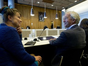 Urgenda director Marjan Minnesma, left, waits for judges to enter the appeals court in The Hague, Netherlands, Tuesday, Oct. 9, 2018, where the Dutch government appealed a 2015 landmark ruling ordering the government to cut the country's greenhouse gas emissions by at least 25 percent by 2020 in a climate case that activists hope will set a worldwide precedent. The case was brought to court by Urgenda, a sustainability organization on behalf of some 900 citizens, claiming that the the government has a duty of care to protect its citizens against looming dangers.