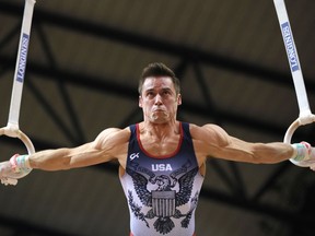 Samuel Mikulak of the U.S. performs on the rings during the men's team final of the Gymnastics World Chamionships at the Aspire Dome in Doha, Qatar, Monday, Oct. 29, 2018.
