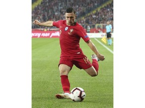 Portugal's Mario Rui passes the ball during the UEFA Nations League soccer match between Poland and Portugal at the Silesian Stadium Chorzow, Poland, Thursday Oct. 11, 2018.