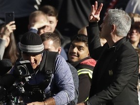 ManU coach Jose Mourinho flashes three fingers after the English Premier League soccer match between Chelsea and Manchester United at Stamford Bridge stadium in London Saturday, Oct. 20, 2018.